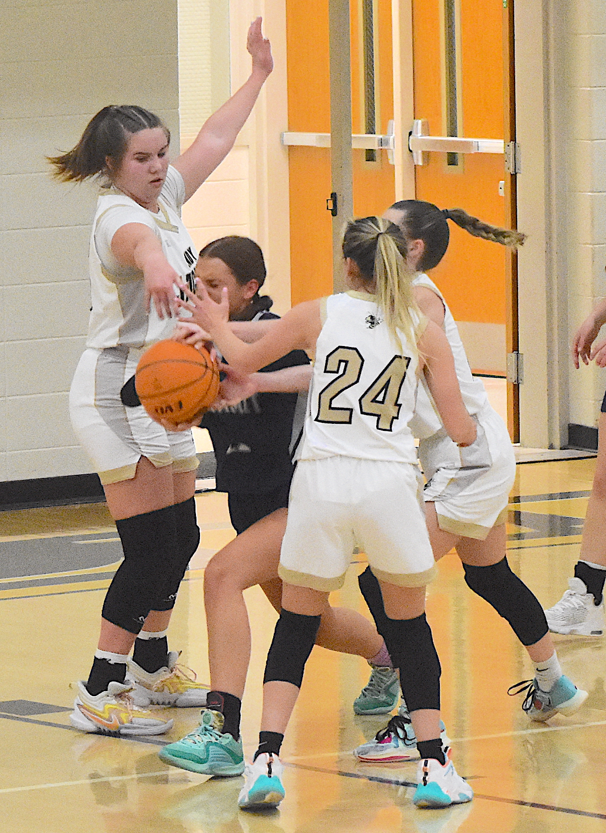Lady Yellow Jackets Mallory Peck, No. 35, Emma Ashe, No. 24, and Ava Shook swarm a Summit player.
