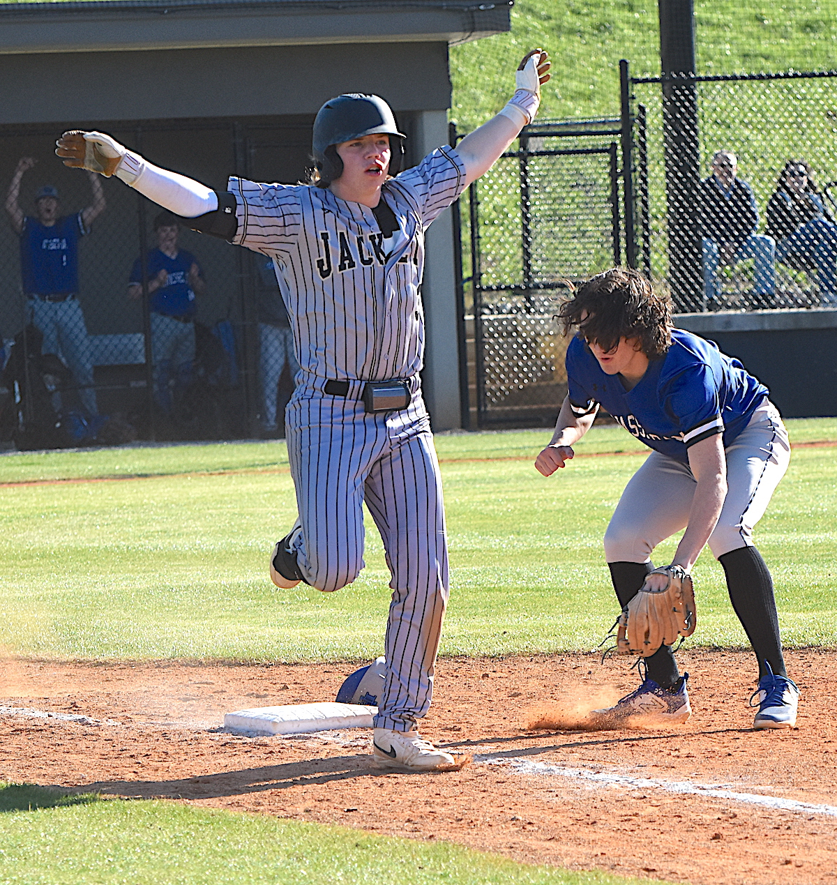 Gary Corsair • Clay County Progress Hayesville's Kyle Shaheen helps the umpire make the call, signaling safe after beating out an infield grounder with two outs in the bottom of the fifth inning against Hiwassee Dam. 