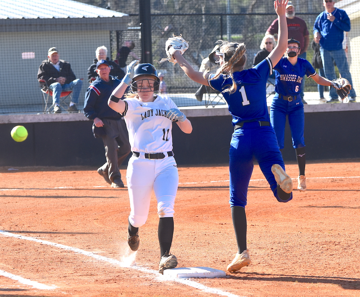 Gary Corsair • Clay County Progress Hayesville's Raylyn Taylor, No. 11, hustles down the first base line safely on a Hiwassee Dam overthrow.