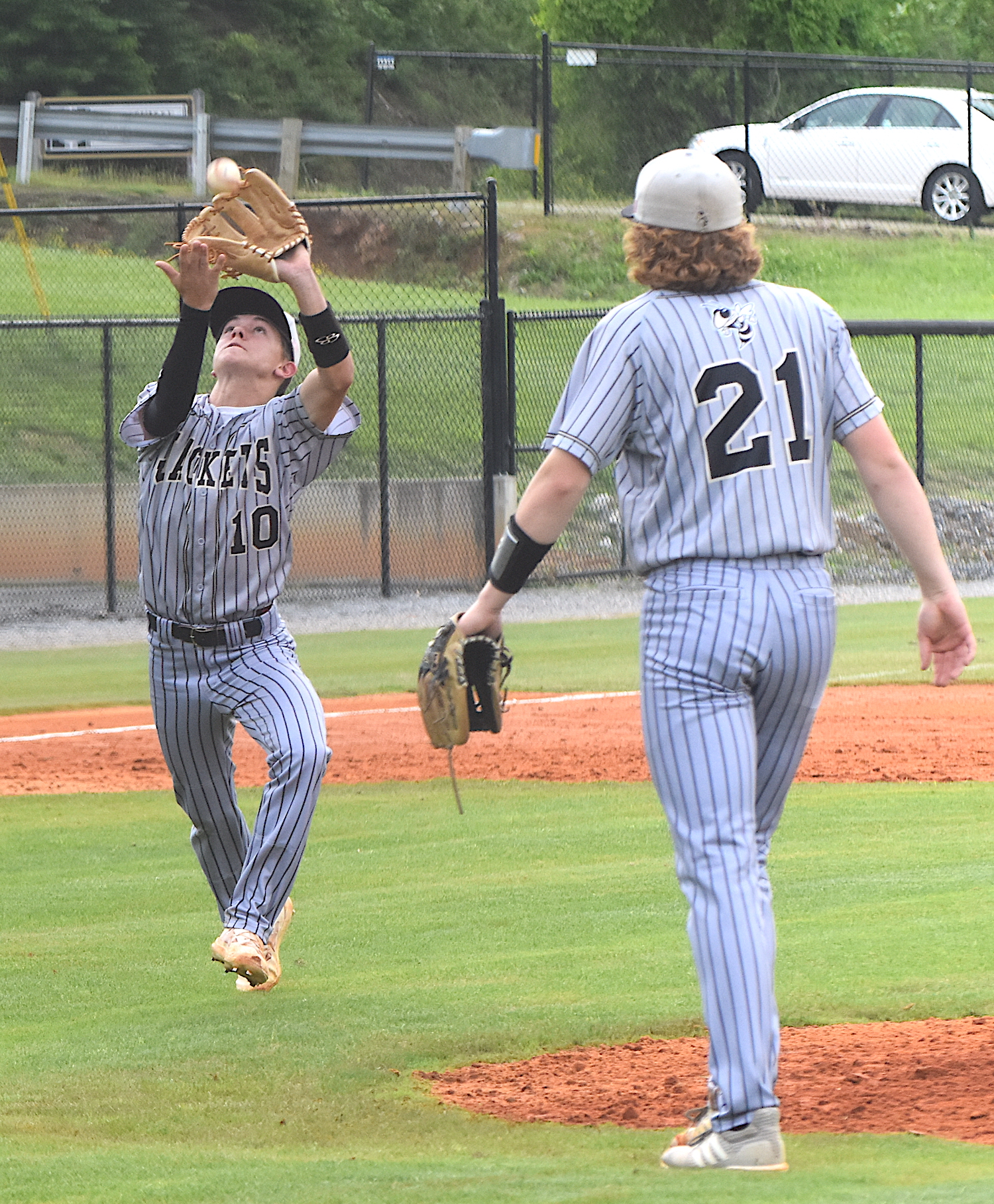 Gary Corsair • Clay County Progress Hayesville third baseman Chance Hughes, No. 10, squeezes a pop-up as pitcher Jackson Sellers, No. 21, comes off the mound. 