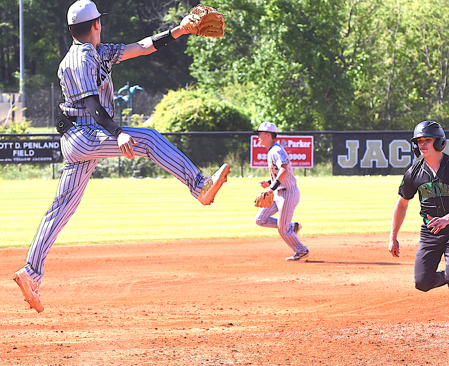 Gary Corsair • Clay County Progress Hayesville third baseman Chance Hughes descends after leaping in an attempt to spear an errant throw over his head.