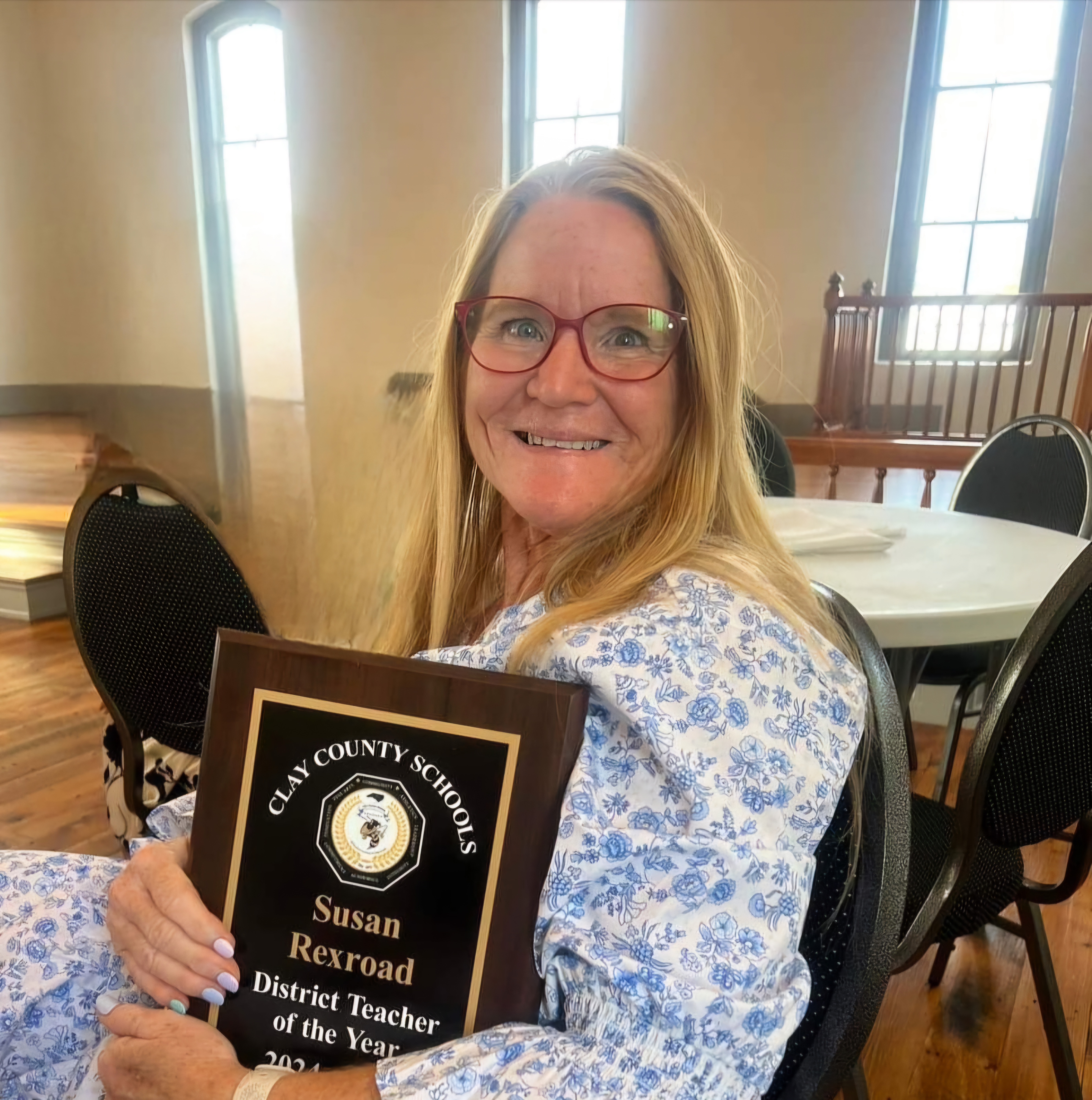 Photo submitted Clay County District Teacher of the Year for 2024-2025 Susan Rexroad holds the plaque she was given during the ceremony held at the Beal Center to honor Clay's Teachers of the Year.