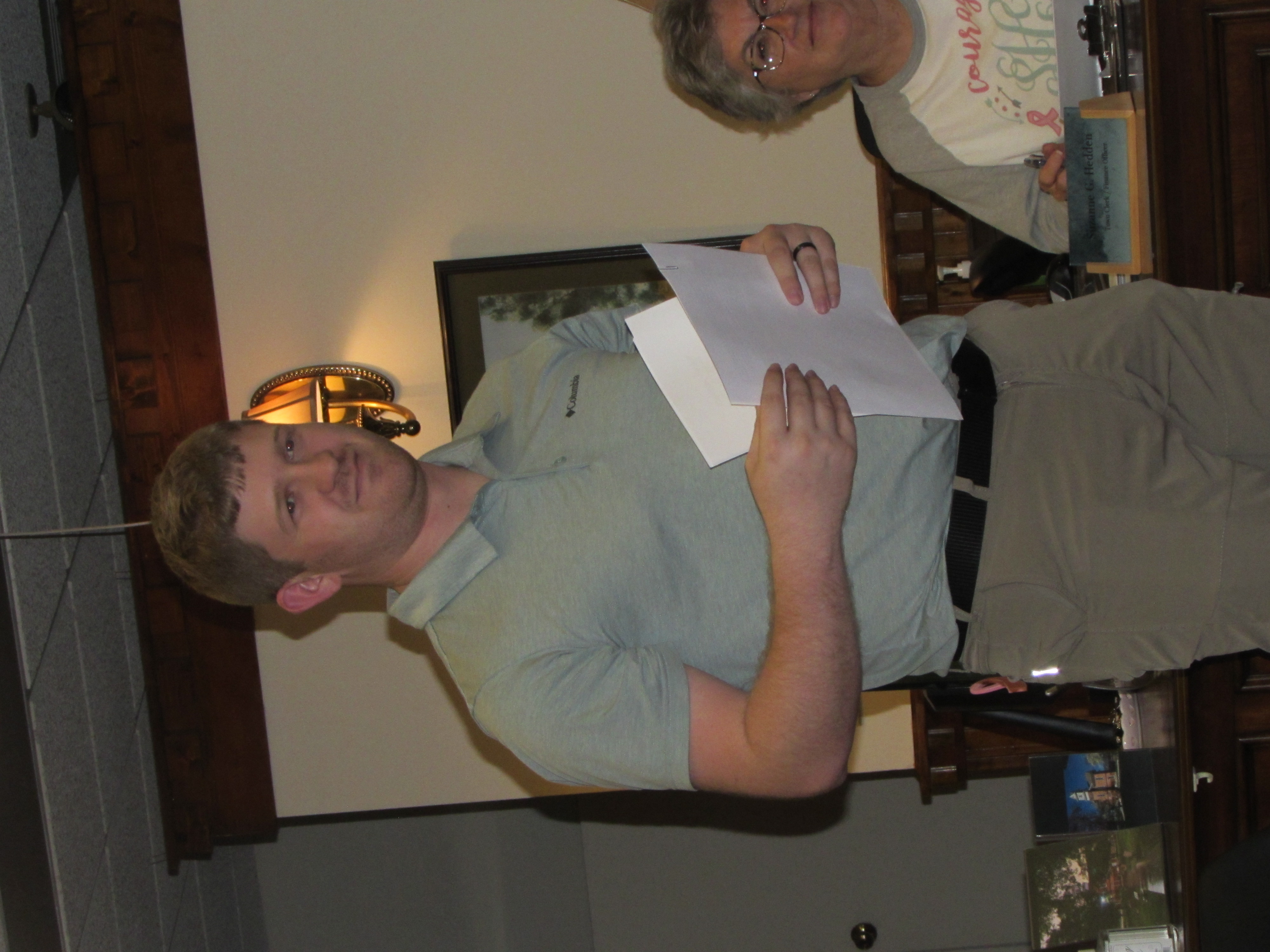 Kaseson Hooper presents the town council with audit reports.