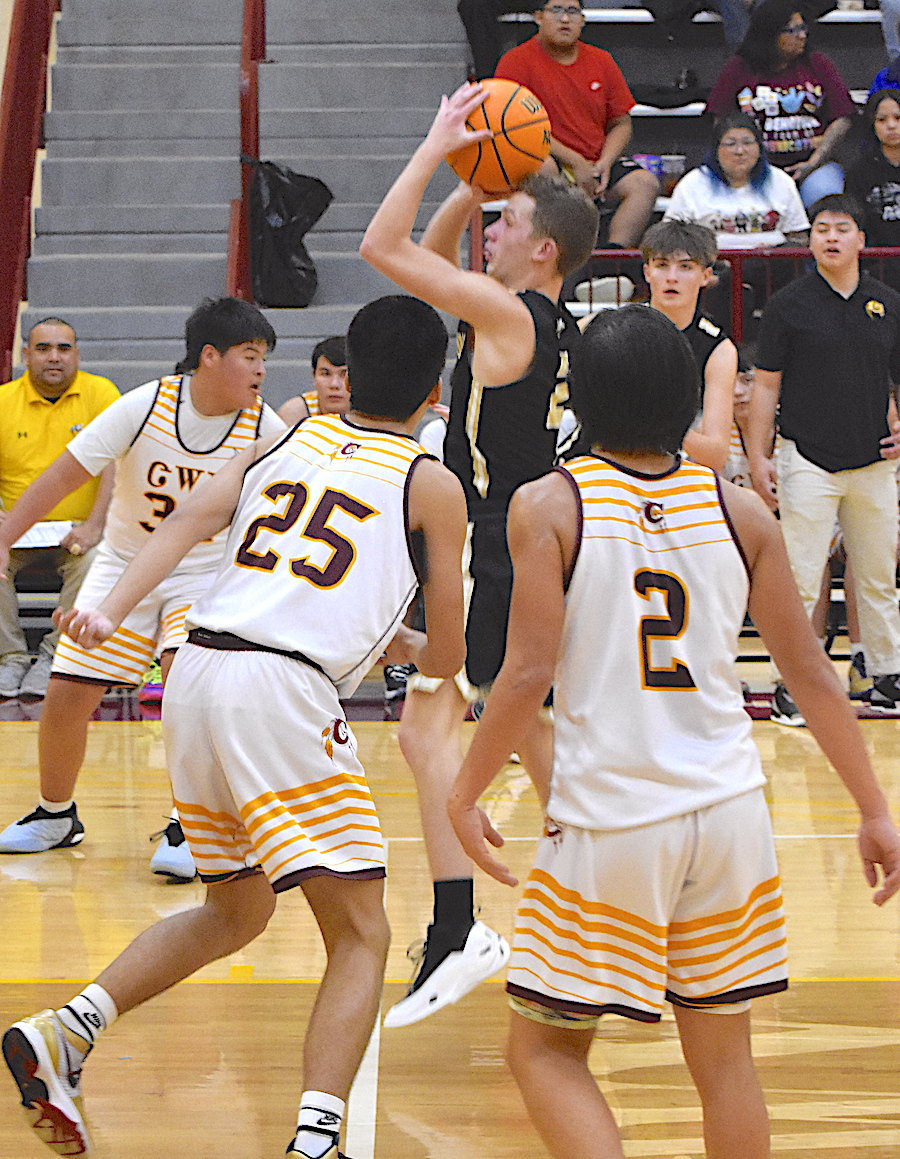 Gary Corsair • Clay County Progress A trio of Cherokee Braves are powerless to stop Micah Moss, No. 2, as the Hayesville guard powers his way to the hoop. 