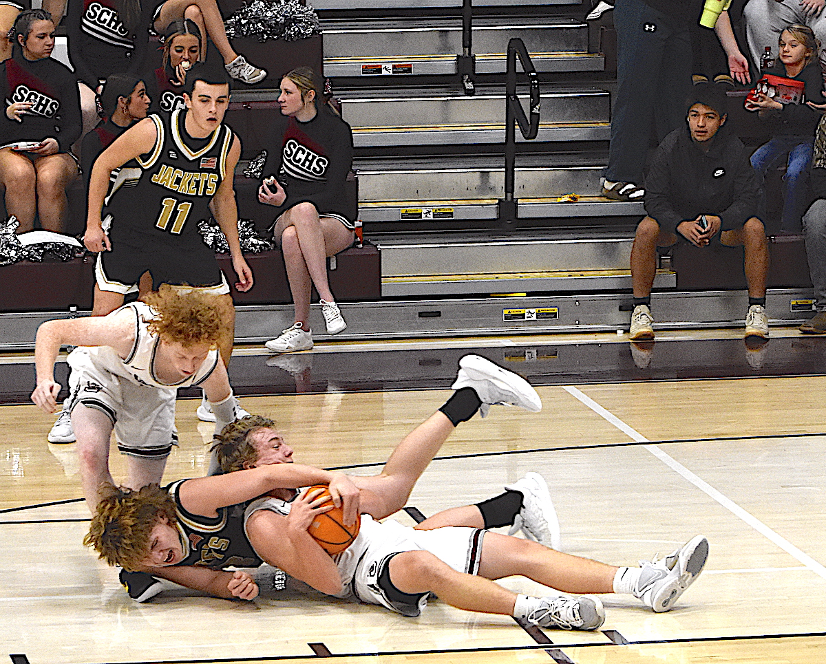 Gary Corsair • Clay County Progress Hayesville big man Jackson Sellers, No. 33, tries to wrestle the ball away from a pair of Swain Maroon Devils and Yellow Jacket Riley Rogers, No. 11, watches.
