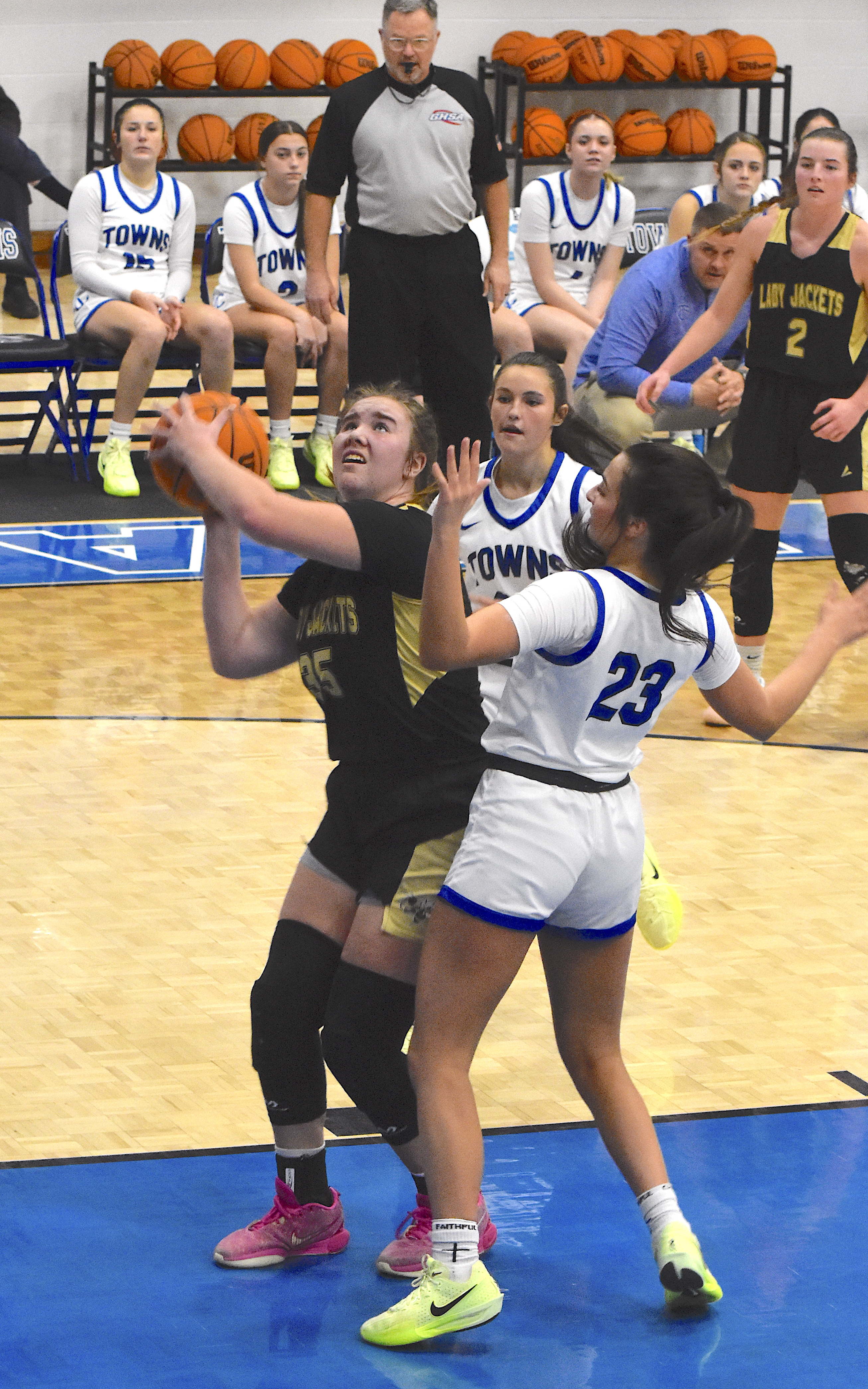 Gary Corsair • Progress Above, Malory Peck, No.35, keep Hayesville in the game with a slick spin move through Towns County defenders.