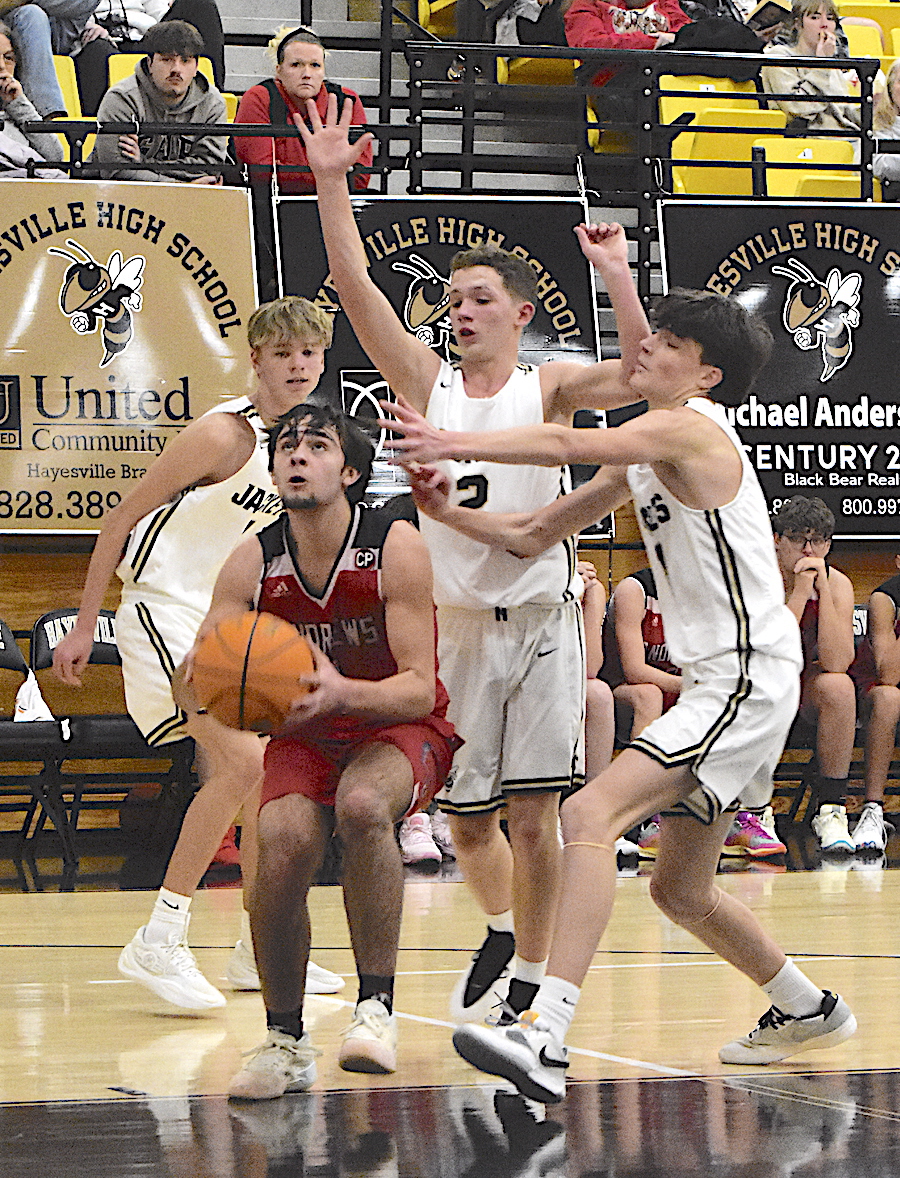 Gary Corsair • Clay County Progress Hayesville's Carter Whitfield, No. 4, Micah Moss, No. 2, and Donovin Soto, No. 11, trap the ball against Andrews.