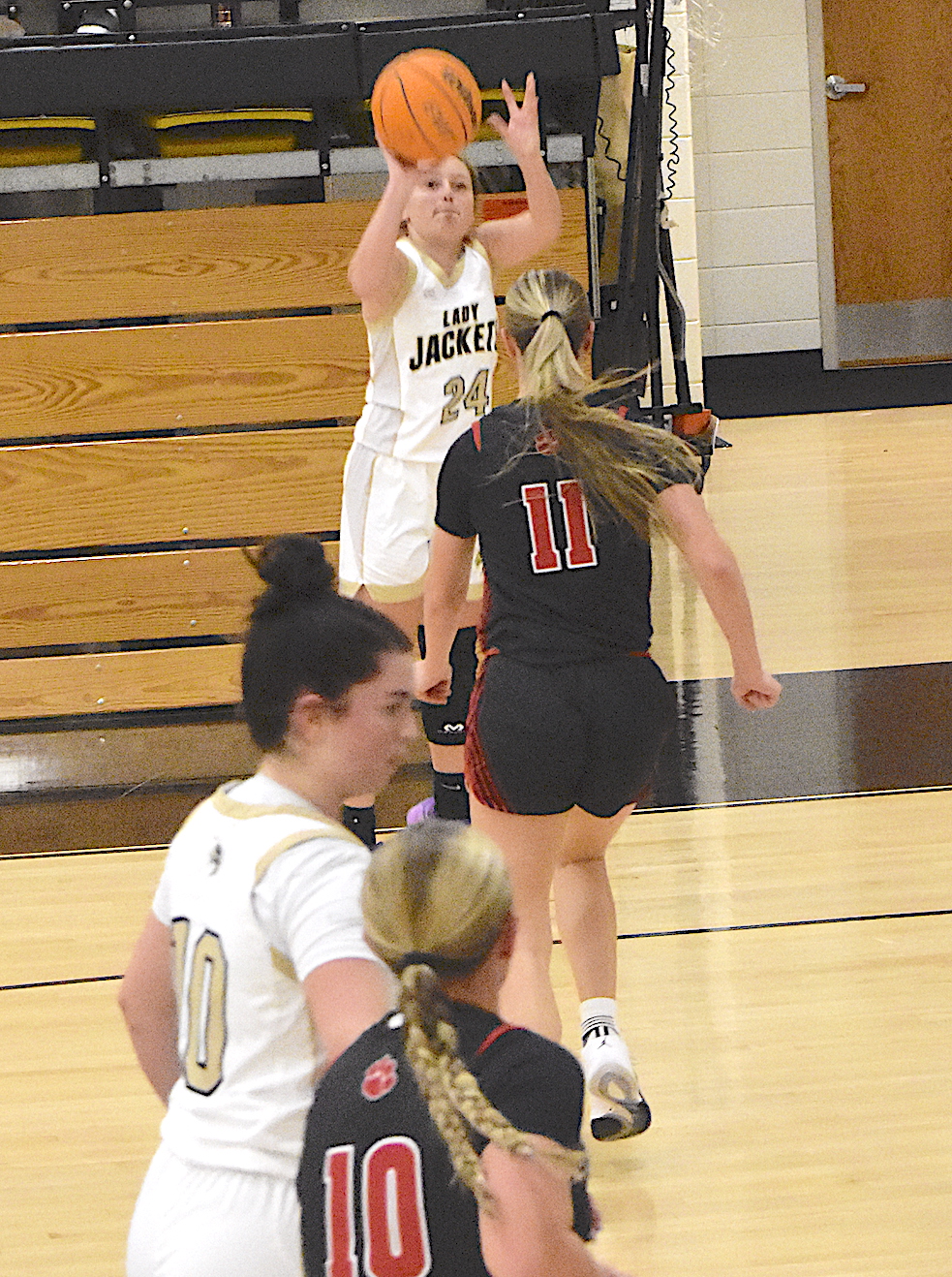 Gary Corsair • Clay County Progress Hayesville's Emma Ashe, No. 24, launches a picture-perfect 3-pointer as teammate Bryleigh Krieger, No. 10, fights for position.