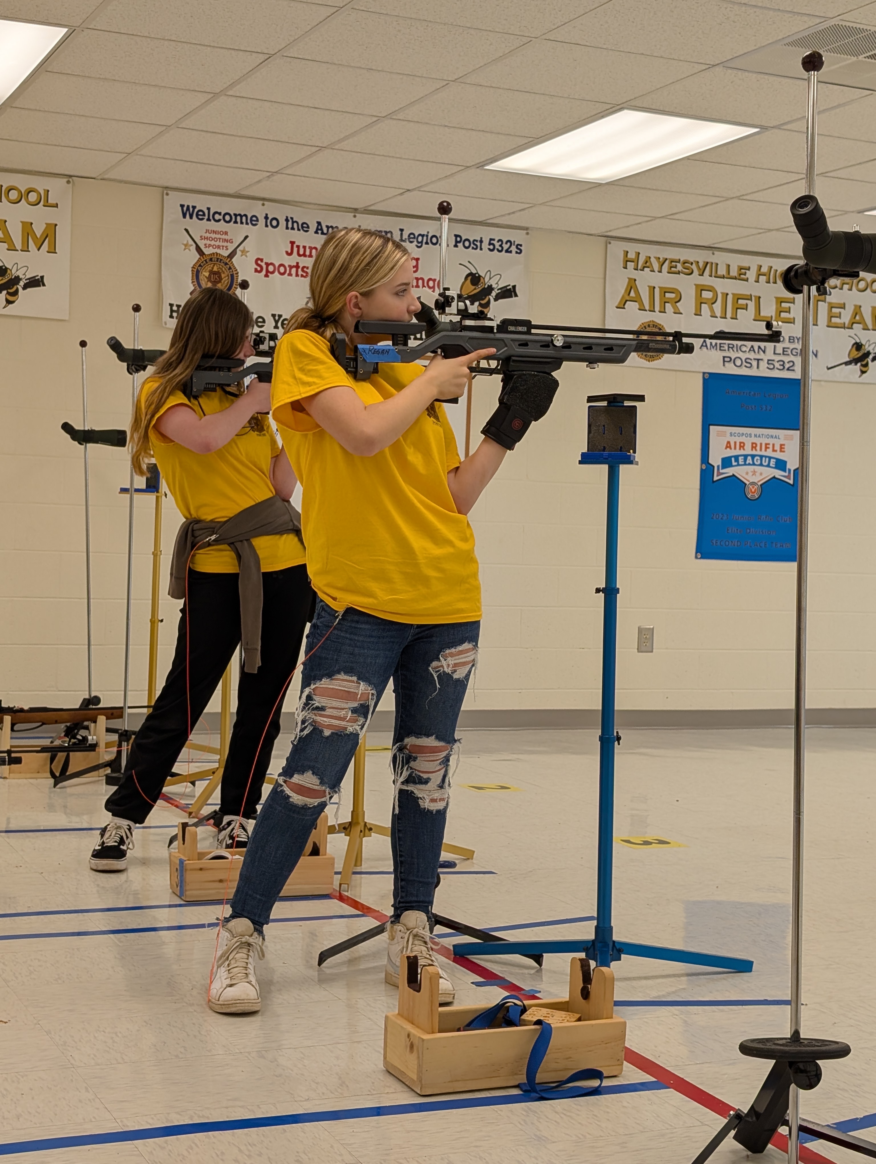 Competing in the standing position at the air rifle competition are, from left, Leyah Parrinello and Regan Schaffer.