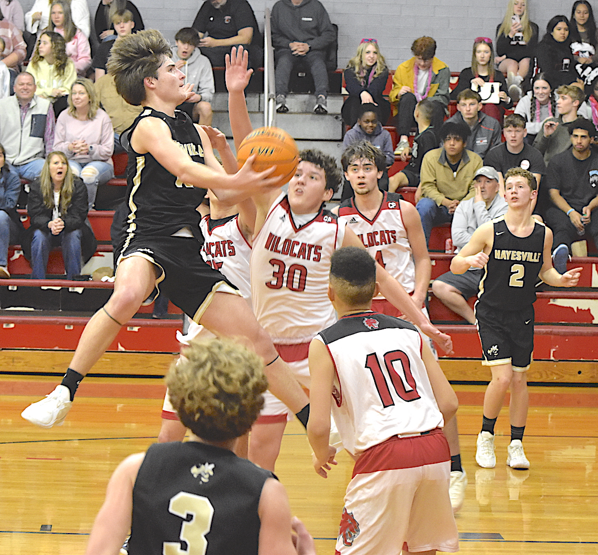 Gary Corsair • Clay County Progress Hayesville's Damien Soto, No. 10, flies high as  he scores on a scoop shot against Andrews.