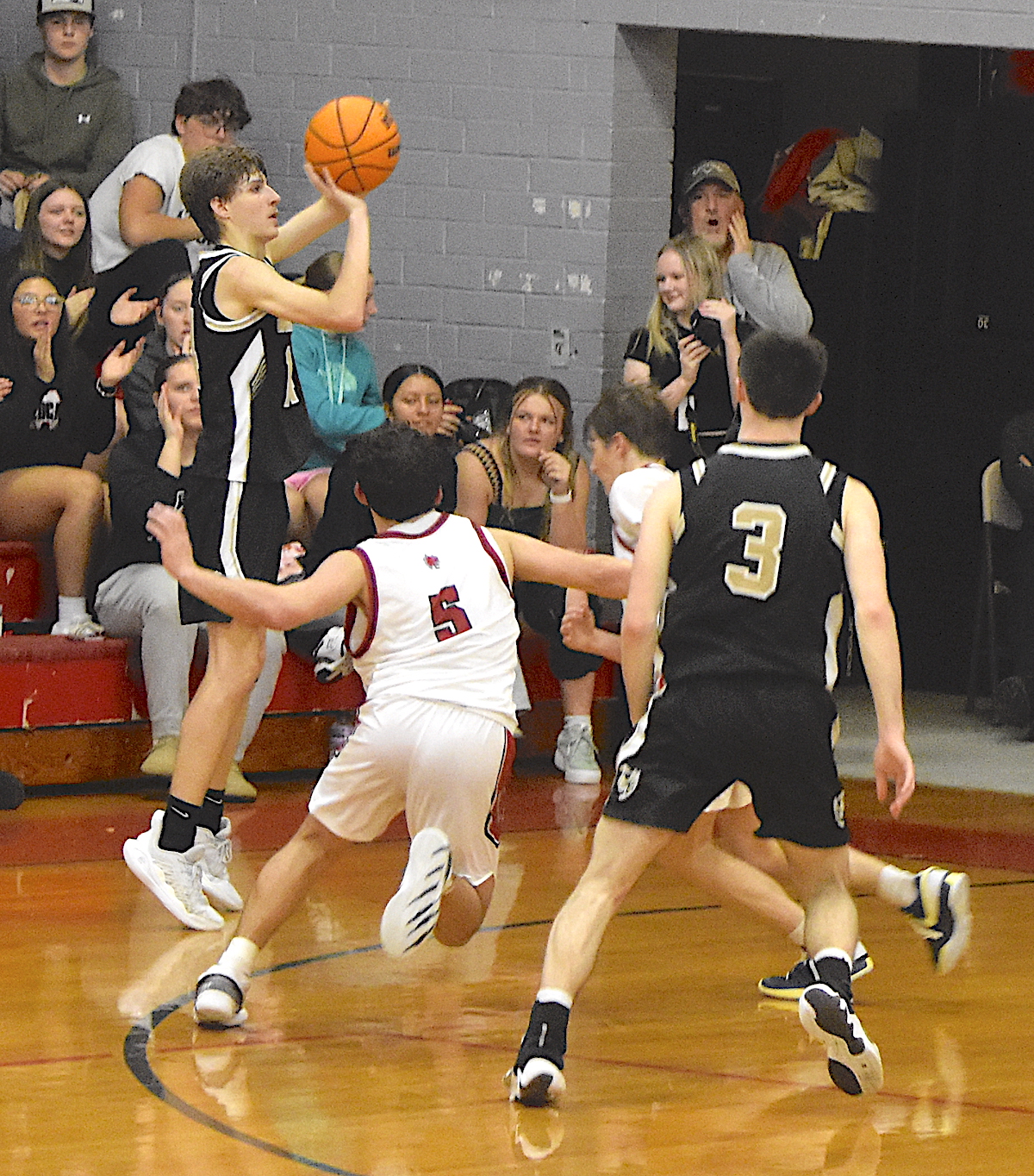 Gary Corsair • Clay County Progress Hayesville sharpshooter Brady Reynolds, No. 14, lofts a 3-pointer from the corner against Andrews.