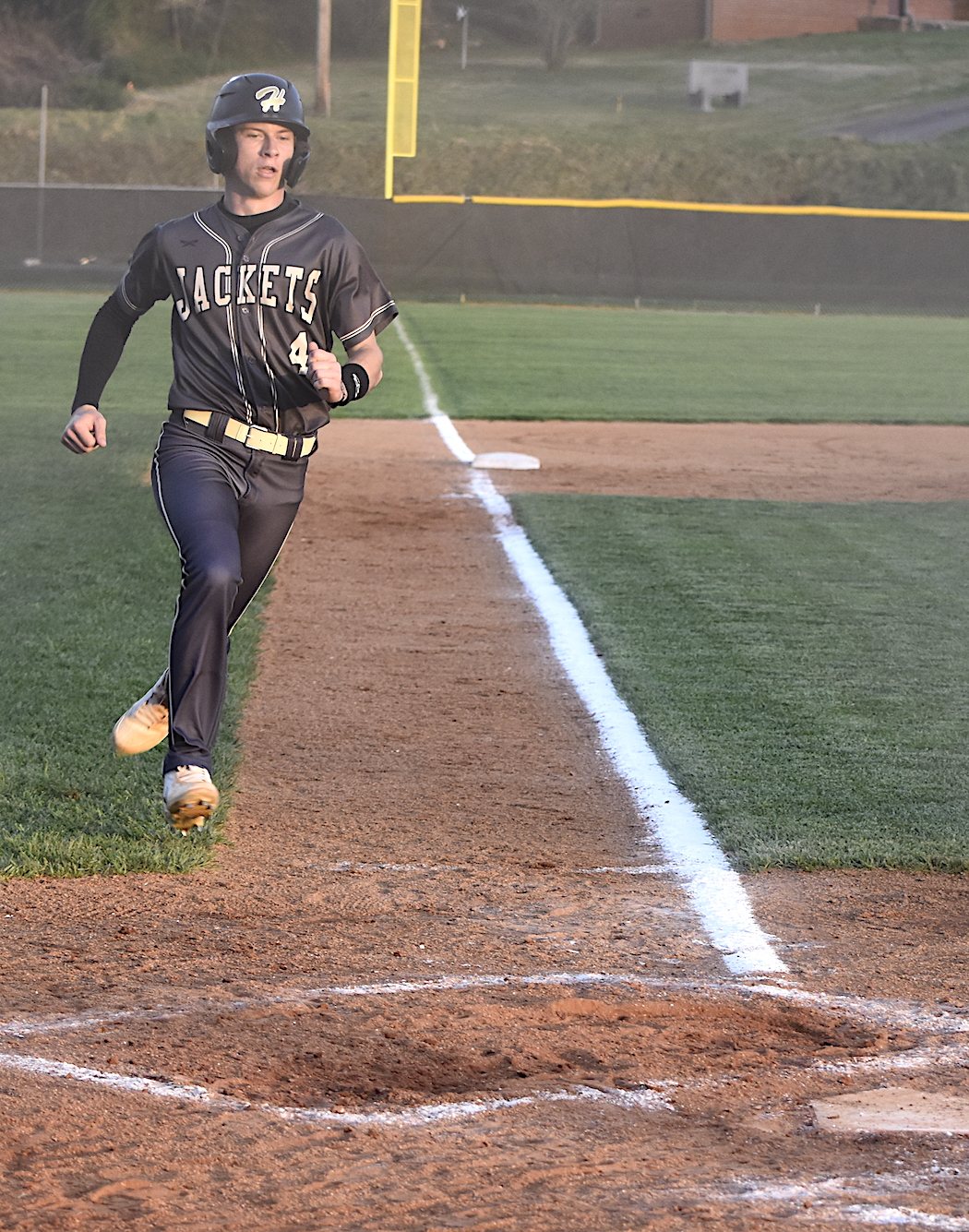 Gary Corsair • Clay County Progress Kendall Boyer prepares to pounce on home plate with Hayesville's first run against Smoky Mountain. Boyer scored when the Mustang third baseman threw the ball away on Dawson Devane's ground ball.