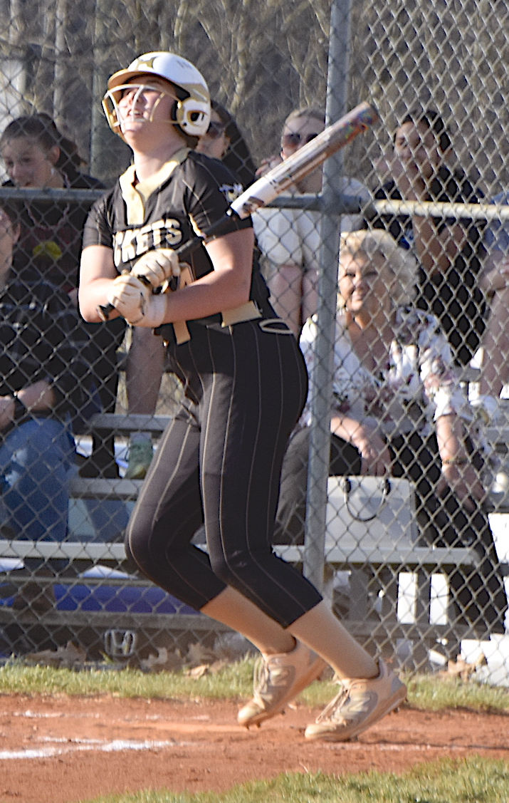 Gary Corsair • Clay County Progress Hayesville slugger Mallory Peck follows through after smacking the softball into the outfield in a recent game. Peck cleared the fence and claimed team leadership in RBI in the process.