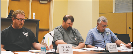 Becky Long • Publisher Commission Chairman Rob Peck, Vice Chair Randy Nichols and Commissioner Dwight Penland review the local budget request from the school system.