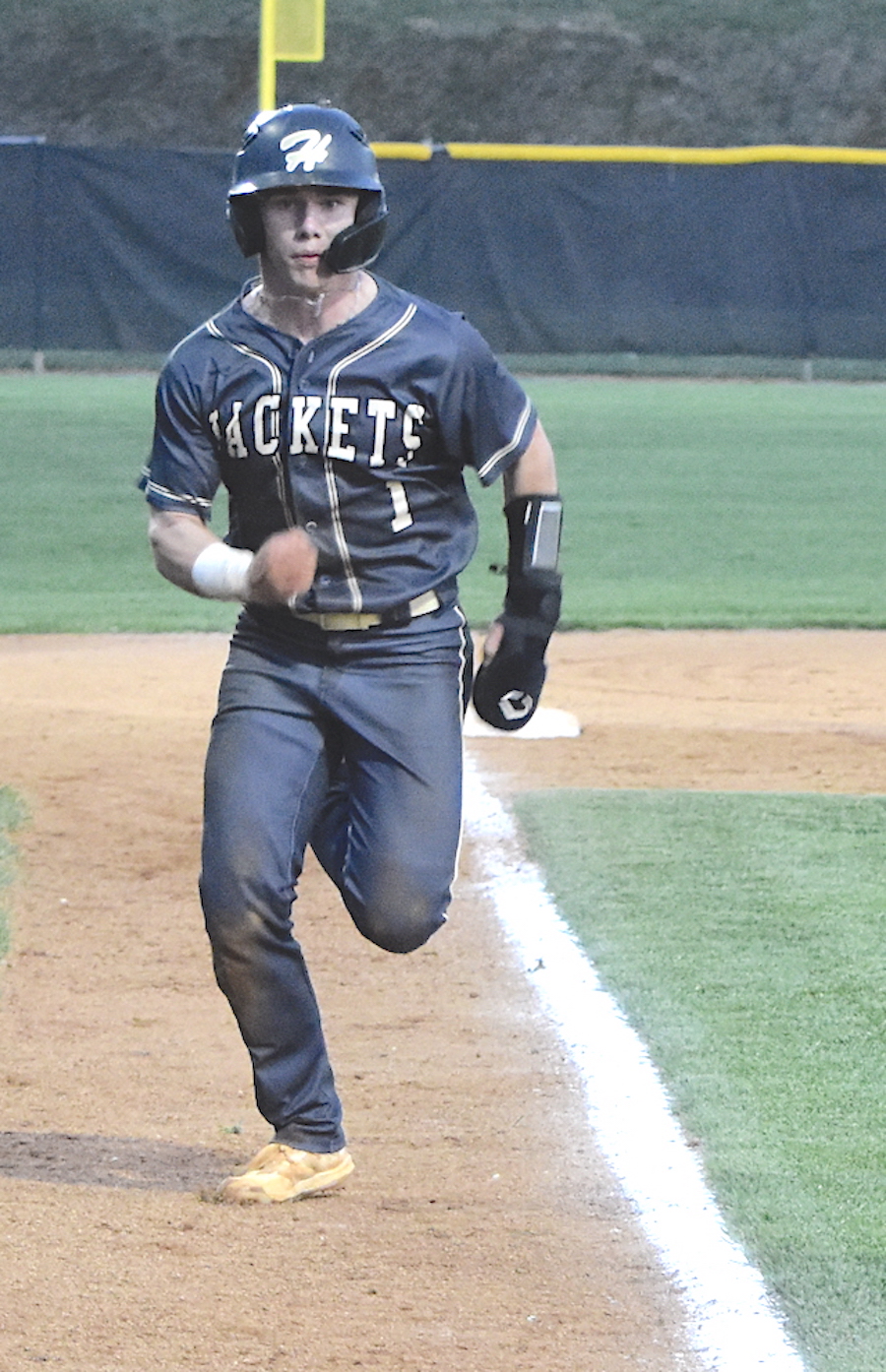 Gary Corsair • Clay County Progress Hayesville leadoff batter Michael Mauney motors home with one of his team-high 21 runs. "Money" Mauney scored five runs in the Yellow Jackets last two games.