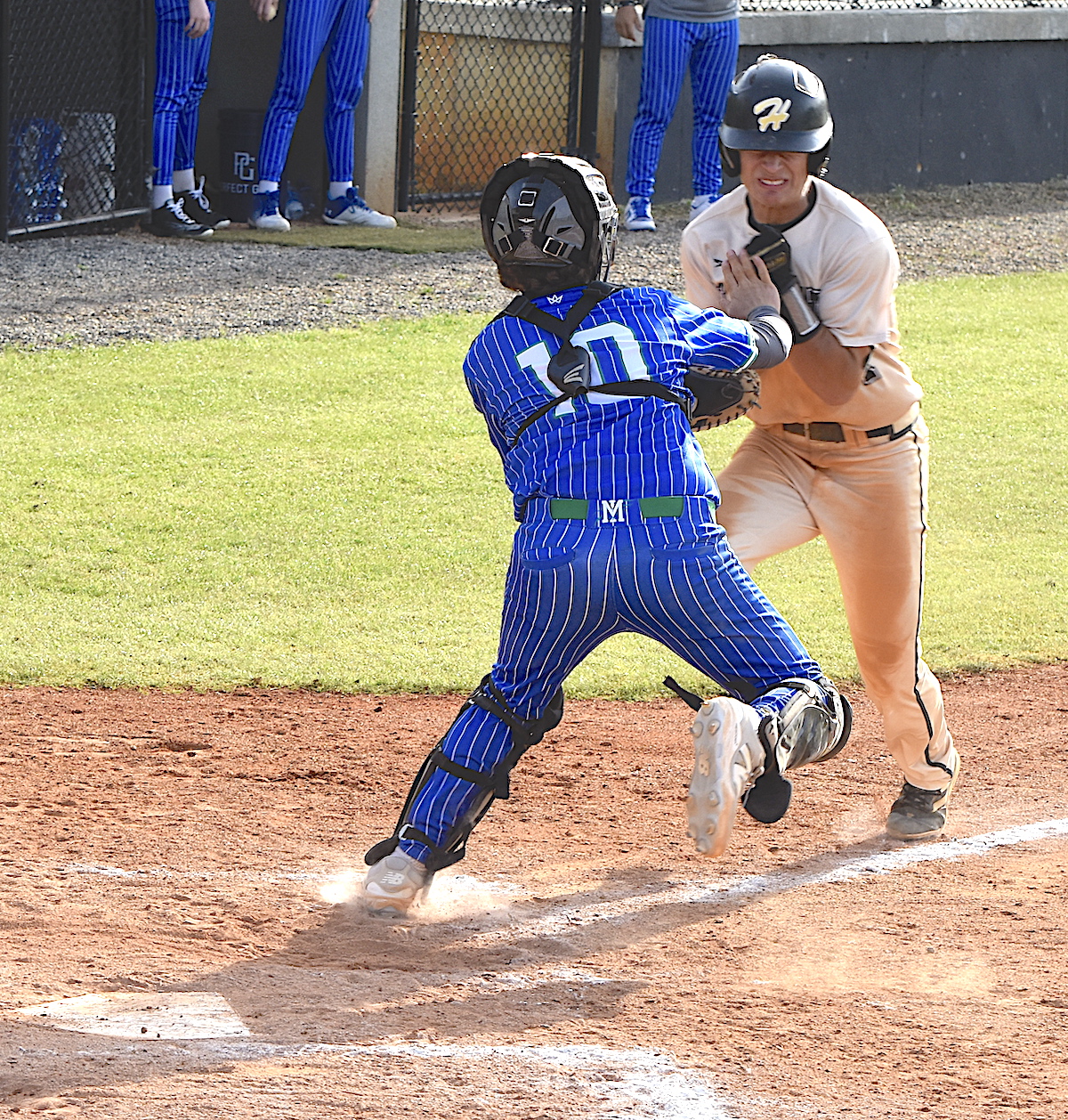 Gary Corsair • Clay County Progress Tate Roberts bowls over the Mountain Island catcher to score the tying run.