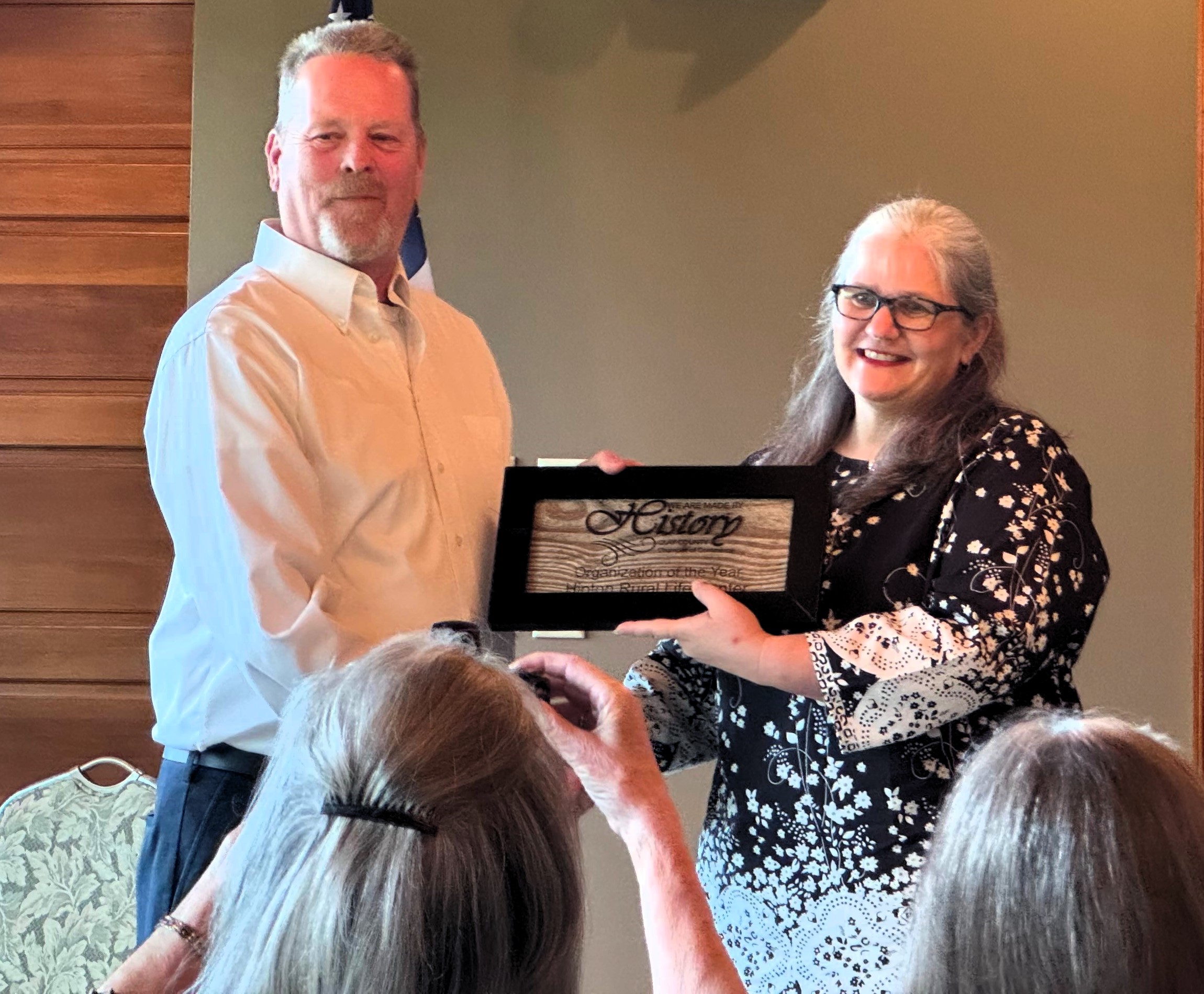 Photo submitted by Hinton Center Clay Chamber Director Jim Rich presents an award to Dr. Jackie Gottlieb, President and CEO of Hinton Rural Life Center. Hinton was named the 2025 Organization of the Year by the Clay County Chamber of Commerce.