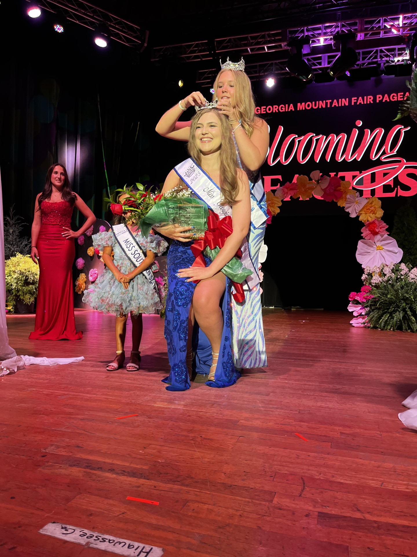 Deby Jo Ferguson • Clay County Progress Amelia Kenlee Shook is crowned by 2024 Rylee Kitchens at the 2025 Georgia Mountain Fair Pageant on Saturday.