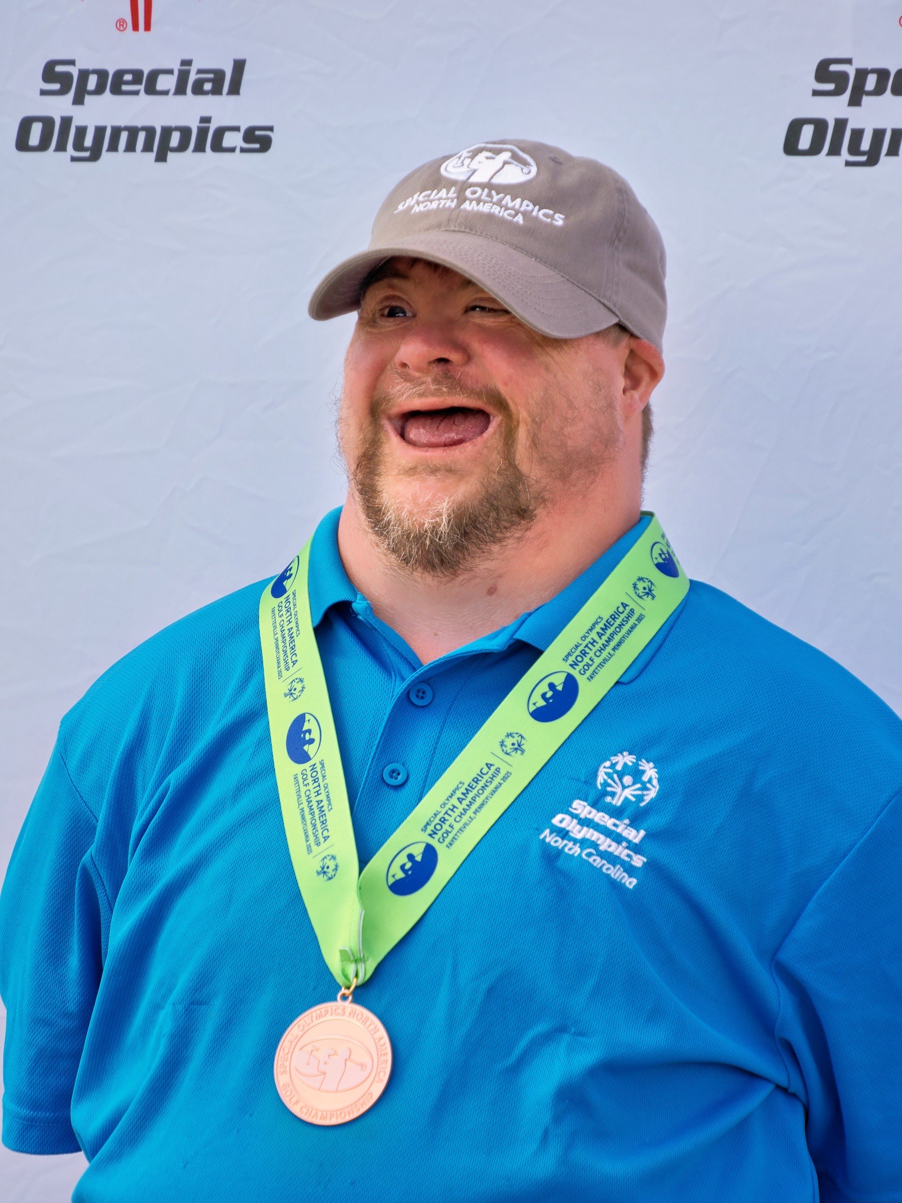 John Riley takes bronze medal at Special Olympics golf championships.