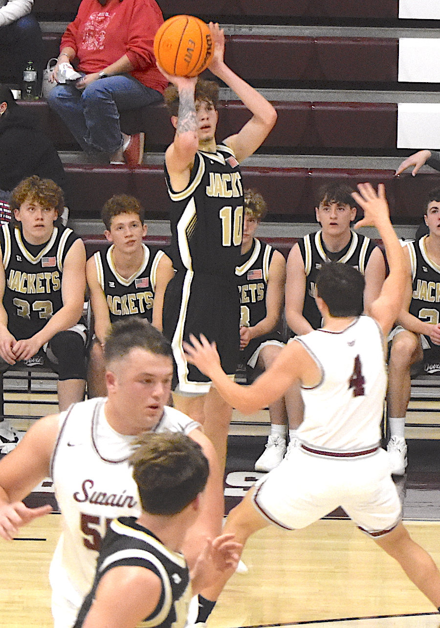 Gary Corsair • Clay County Progress Yellow Jacket Brendan Lynch launches a three-pointer in Hayesville's 82-62 blowout of Swain.