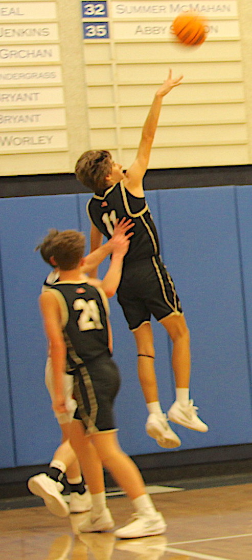 Neal Wachob •  Clay County Progress Brady Reynolds, No. 11, lofts a silky smooth one-hander as Micah Moss, No. 21, watches. Reynolds torched Nantahala for 28 points as Hayesville remained undefeated.