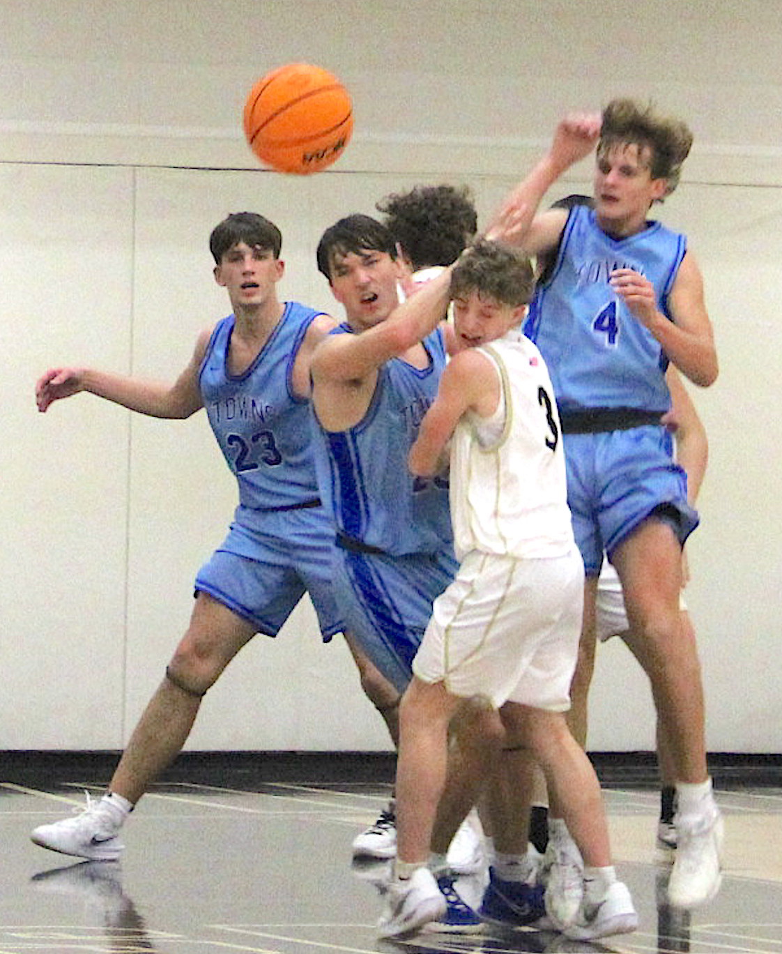 Neal Wachob • Clay County Progress Towns County players give Hayesville's Kabe Shaheen, No. 3, a rude welcome as he drives the lane. Imagine Shaheen's surprise that no foul was called.