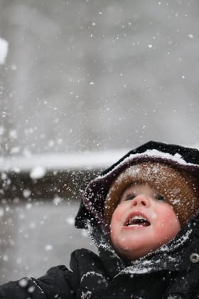 Marshall Foster tries to catch as much snow as he can before mom coaxes him out of the cold with hot cocoa.