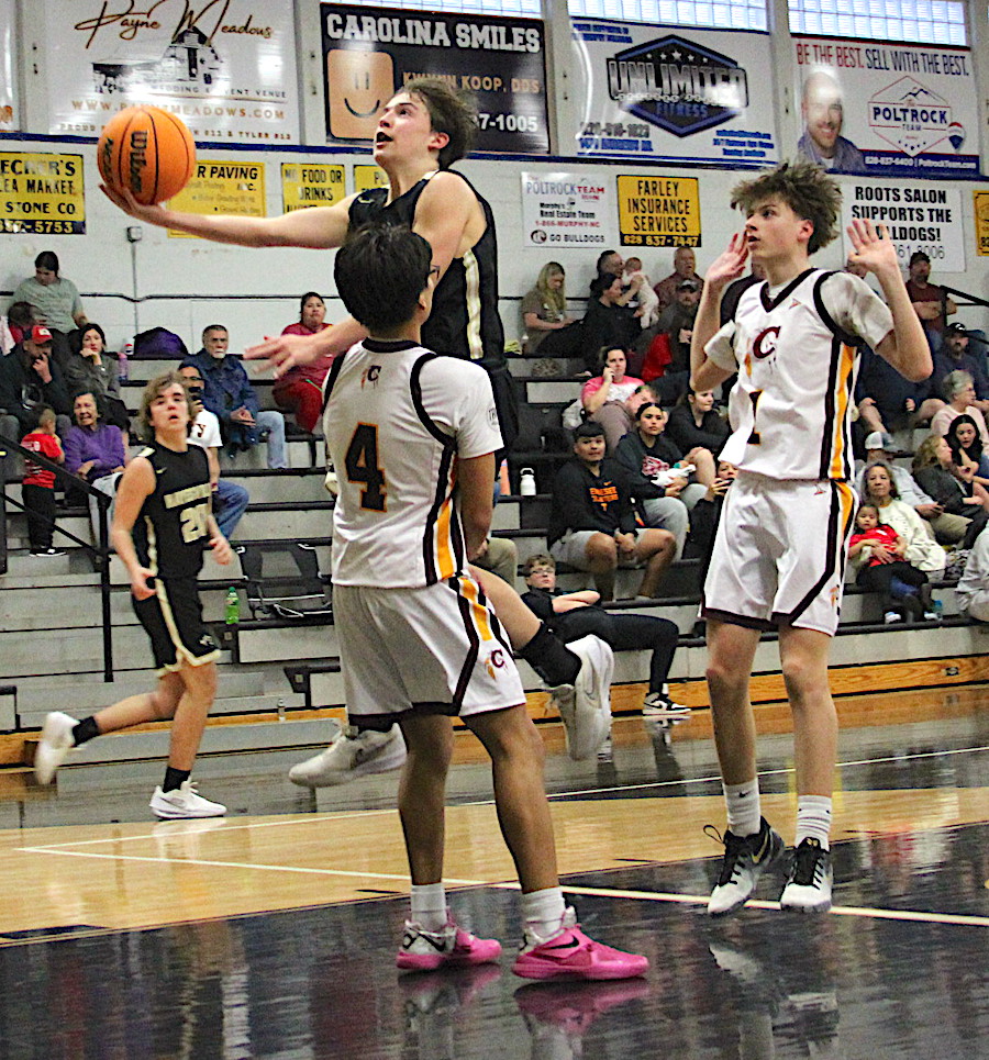 Neal Wachob • Clay County Progress Byron Engelmann, No. 15, surprises Cherokee with a scoop shot to tally 2 of his team-high 9 points for Hayesville's JV boys.