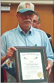 Dwight Penland receives a plaque signifying his induction in The Order of the Lone Leaf Pine on Oct. 2, 2025.