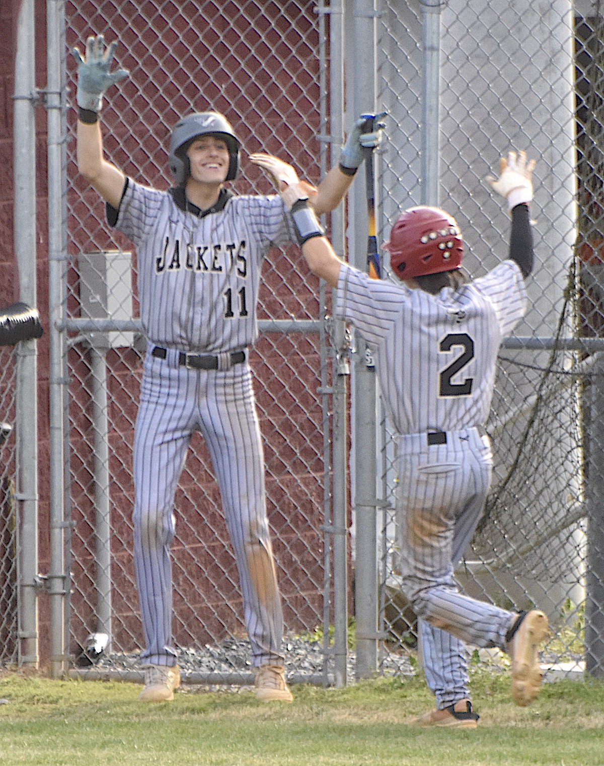  Photo by Gary Corsair Hayesville standouts Brady Reynolds, No. 11, and Rob Barter, No. 2, celebrate one of 16 runs the Yellow Jackets plated in five innings against Swain County. 