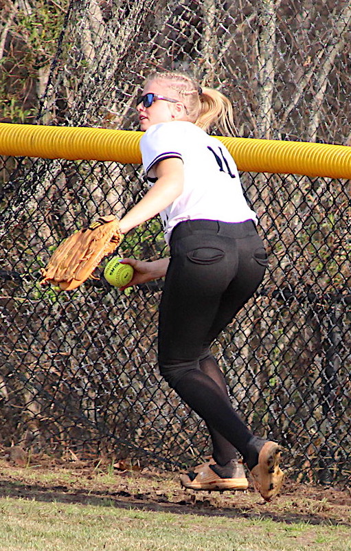 Hayesville center fielder Isabella Mintz looks for the cutoff player after running down a long fly ball.