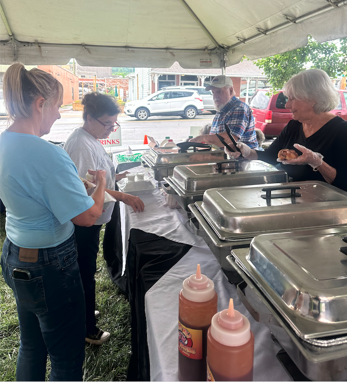 Sandy Zimmerman and Sherry Garrett take a break from giving rides during the festival to get a bite to eat at the food tent.