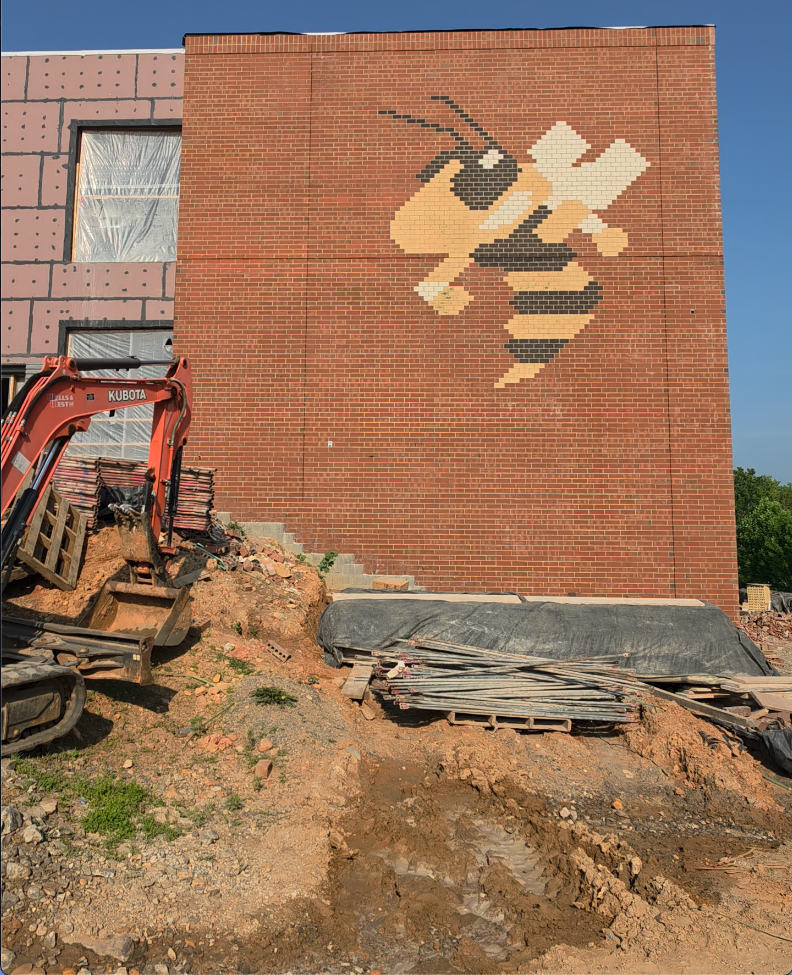 An outer brick wall of the new Hayesville Intermediate School under construction is defined by the yellow jacket mascot of Clay County Schools.