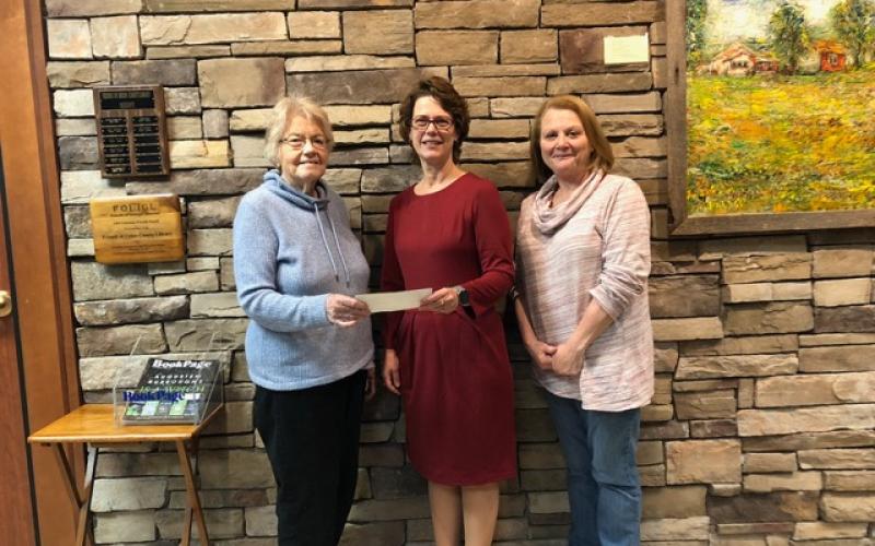 DAR presents a $500 donation. Sandie Harbuck, Chapter Librarian and Cayce Friedly, Corresponding Secretary, both of Blairsville, presented a check to Carol Knight, center, Principal of Woody Gap.