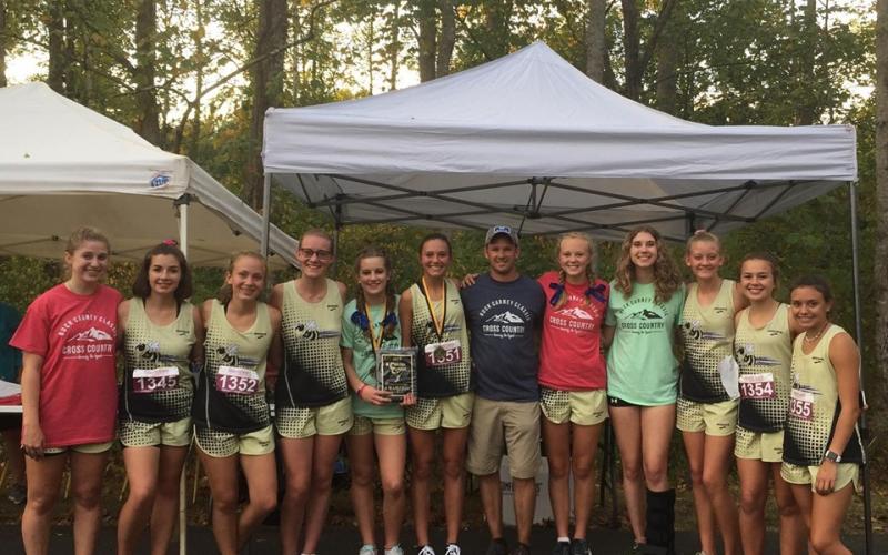 Colleen Urbaniuk • Submitted  //  The Lady Yellow Jackets celebrate the Carney Classic victory. From left, Allison Thomas, Meg Barton, Samantha Moral, Leah Hatherly, Caroline Burch, Kayson Krieger, coach Zach Moss, Cecilia Jones, Elizabeth Beck, Serina Penland, Lila Roberts and Meadow Rose.