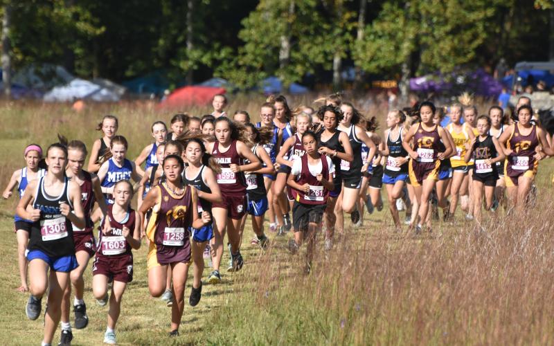 Travis Dockery • Clay County Progress //  A field of 70 runners launch for the start of the middle school girls’ portion of the Carney Classic held at Chatuge Dam.