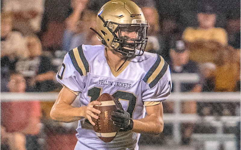 (Photo by Kevin Hensley) Quarter back Hayden McClure scrambles as he looks for an open receiver.
