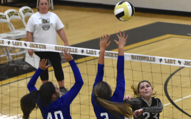 (Travis Dockery • Clay County Progress)  Jena Baldwin pushes the ball just over the finger tips of Hiwassee Dam’s net defender.