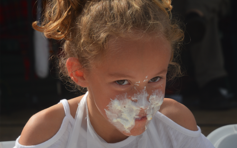 (Lorrie Ross • Clay County Progress) The pumpkin pie eating contests held at 2:30 p.m. each day are popular for all ages. Young and old are cheered on as they each eat their way through a pumpkin pie, covered with whipped cream.