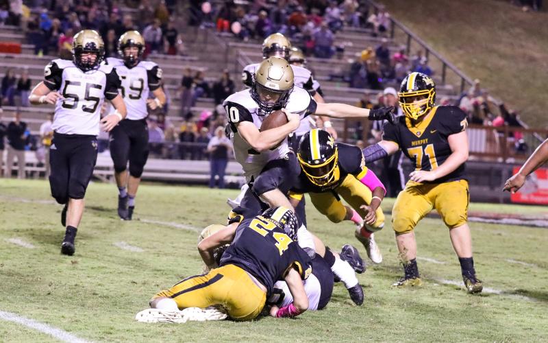 (Kelli Graves • Clay County Progress) Quarterback Hayden McClure ping-pongs off of several defenders in search of points.