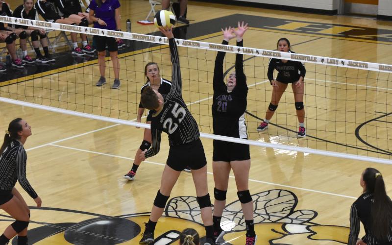 Senior Kat Davis wins the battle at the net as she sends the ball towards an open gap on the floor.  Travis Dockery • Clay County Progress