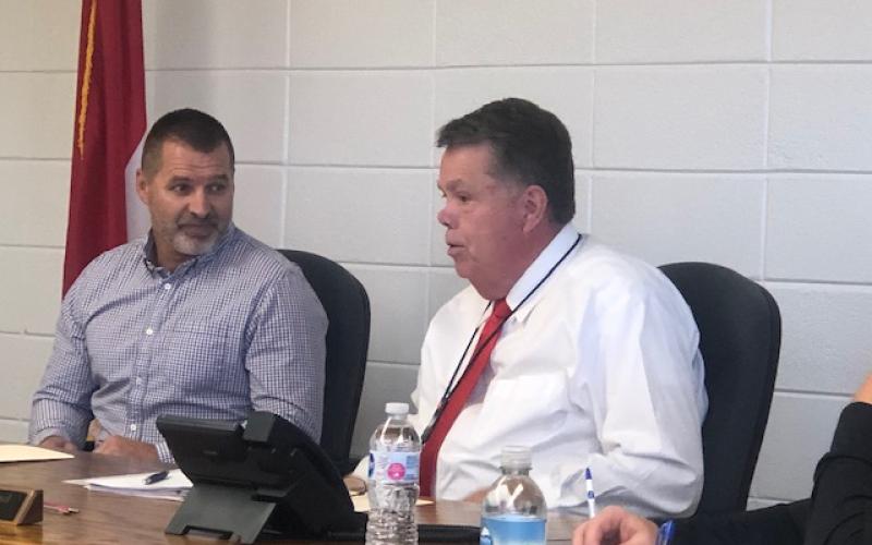 (Lorrie Ross • Clay County Progress) The October meeting of the Clay County Board of Education should be Scotty Penlands’ last meeting as Acting School Superintendent since Dale Cole will begin Friday, Nov. 1. At the October 17 meeting, Board of Education Chairman Dr. Jason Shook, left, laughs as Penland describes serving food in the school cafeteria earlier in the week.