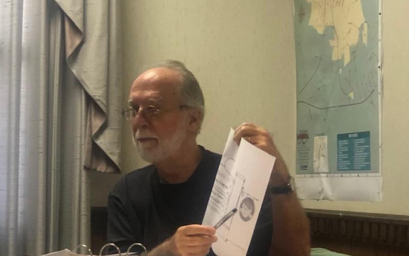 (Lorrie Ross • Clay County Progress) Hayesville Town Councilman Joe Slaton shows a drawing of proposed changes to the Town of Hayesville signs.