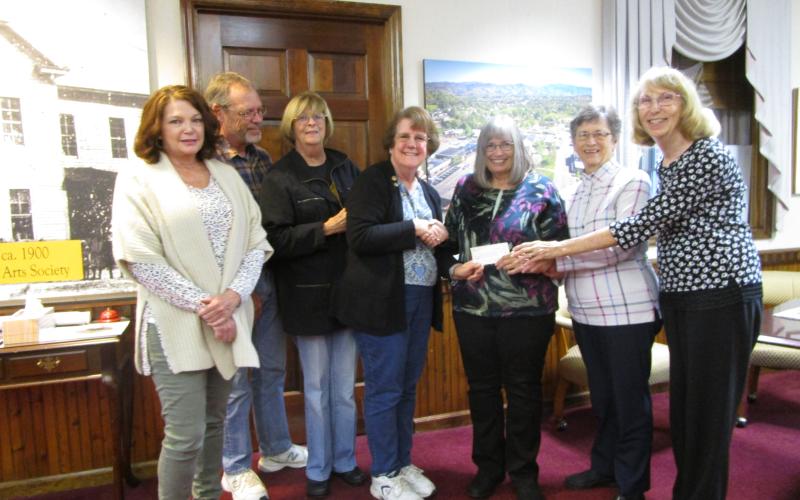 Historic Hayesville Inc. volunteers, from left, Lynn Myers, Stu Jenner, Roni Davis and HHI Board Treasurer Deborah Nichols presents a check from Steins &amp; Wine Around the Square ticket sales totaling $7,287 to Clay County Historical &amp; Arts Council members Dianne Burd, Sara Smith and Reba Beck for Old Jail Museum repairs scheduled for this winter. Both groups expressed appreciation to all sponsors and volunteers who made the 7th annual event a successful fundraiser.