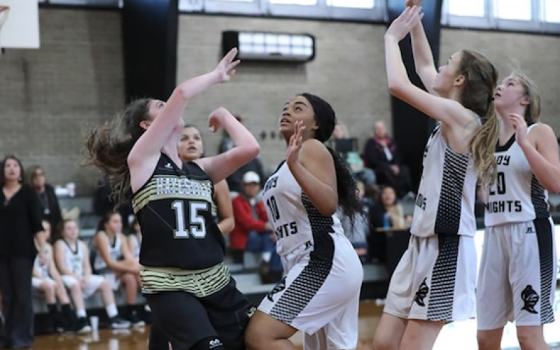 (Kelli Graves  • Clay County Progress) Madison Martin battles a trio of Lady Knights underneath the basket Monday.