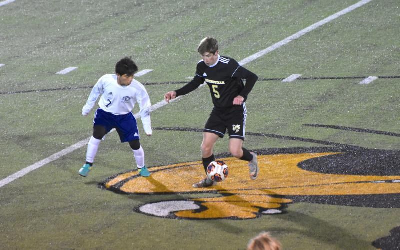 (Travis Dockery • Clay County) Progress Lee Anderson tries to protect the ball and advance toward the goal against Queen’s Grant.