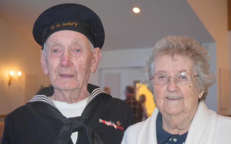 (Progress photo by Lorrie Ross)  A Navy veteran of World War II, Hoke Henson of Peachtree, led the Pledge of Allegiance during the 2018 Veteran's Day ceremony and stood proudly with his wife after the solemn service. Hoke Henson was Navy Fire and Rescue. As they posed for the picture, Edith Henson smiled and said, "We have been married 71 years."
