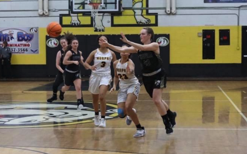 (Kelli Graves * Clay County Progress) Kynnly McClure shoots a pass across the court as Lady Bulldogs give chase.