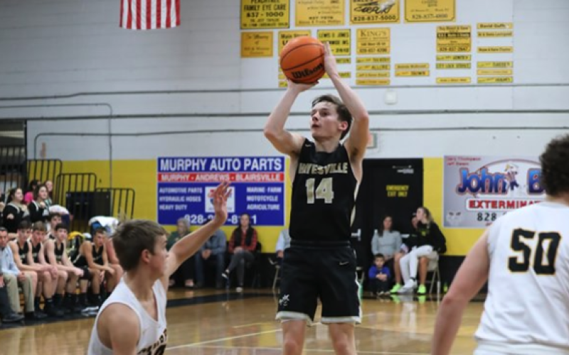 (Kelli Graves * Clay County Progress) Sophomore Kolbe Ashe goes above defenders to get a clear shot at the basket.