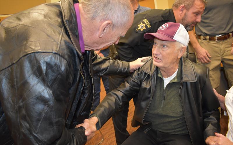 (Becky Long • Clay County Progress) Former sheriff Tony Woody receives congratulations from former sheriff, Vic Davis.